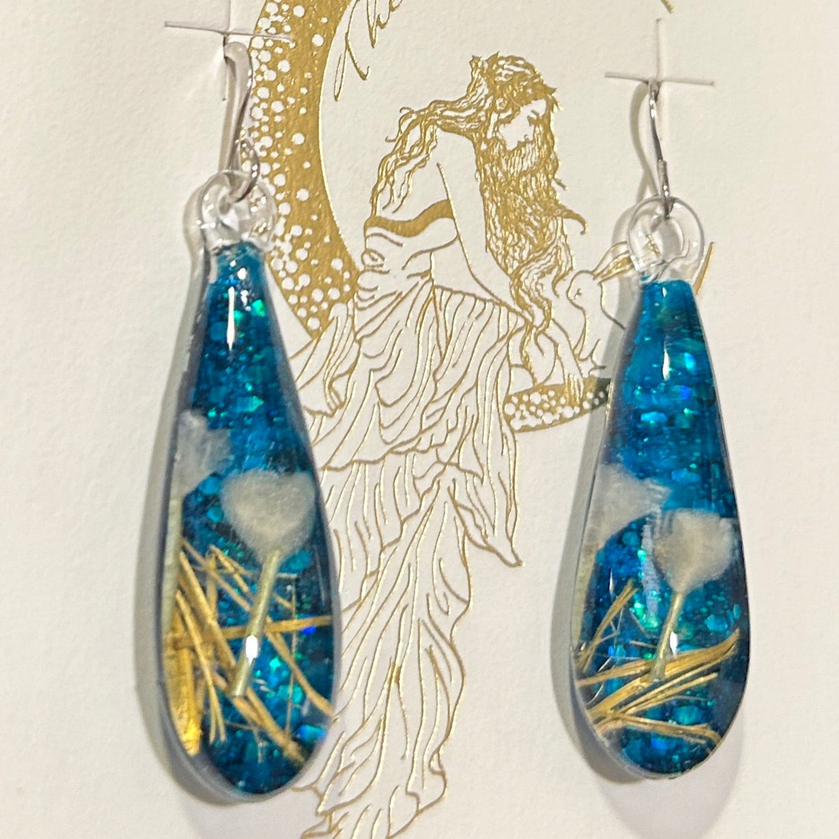 Handmade botanical dichroic glass drop earrings 2.1 inches long with real dried grass straws suspended in blue glass on sterling silver ear wires
