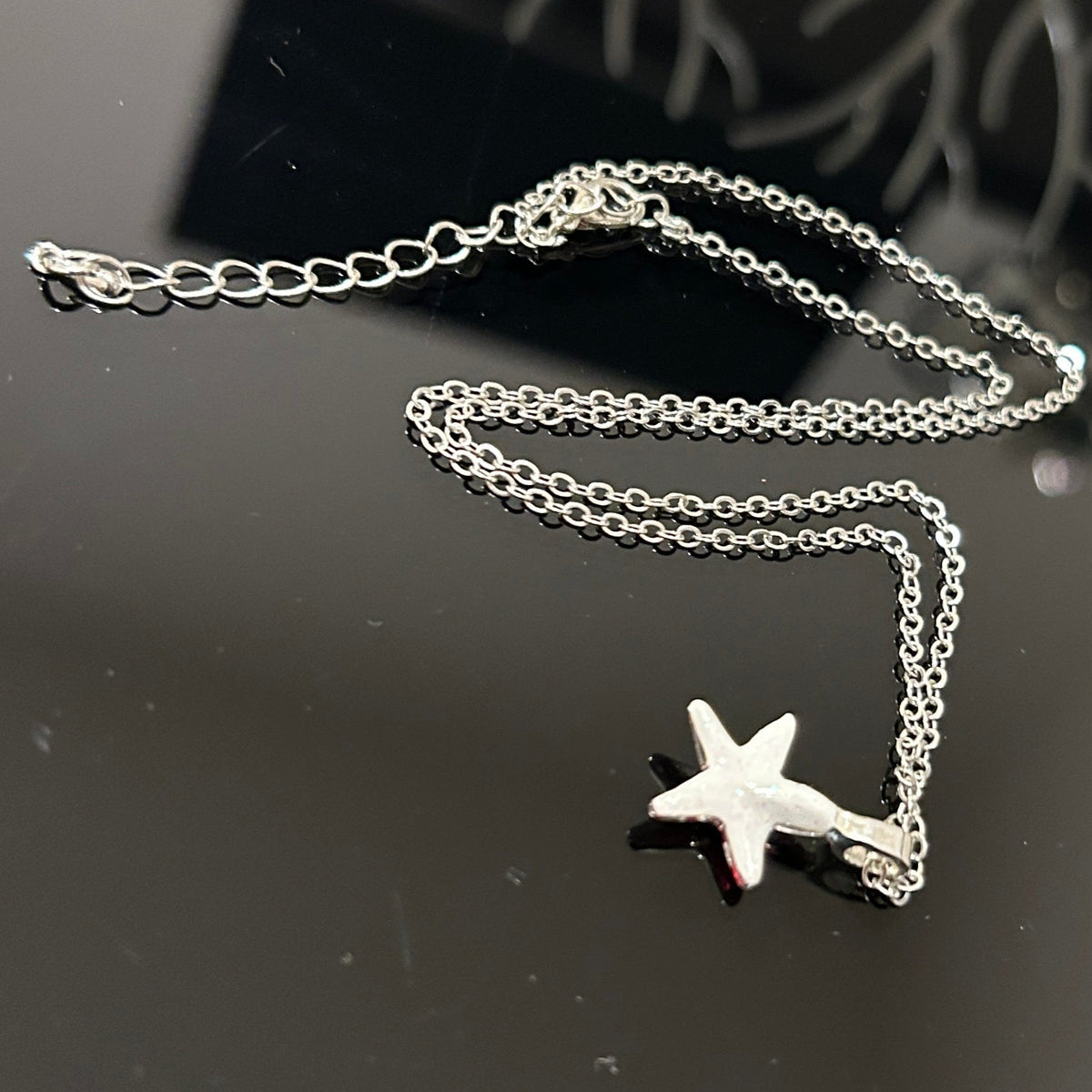 Handmade dichroic glass starfish pendant 1 inch with color-shifting pink effects on 21 inch sterling silver chain