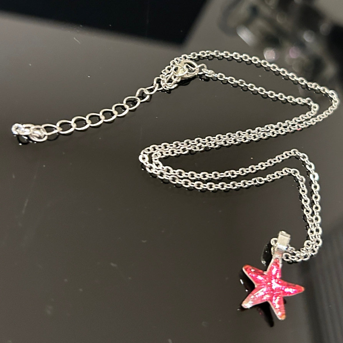 Handmade dichroic glass starfish pendant 1 inch with color-shifting pink effects on 21 inch sterling silver chain