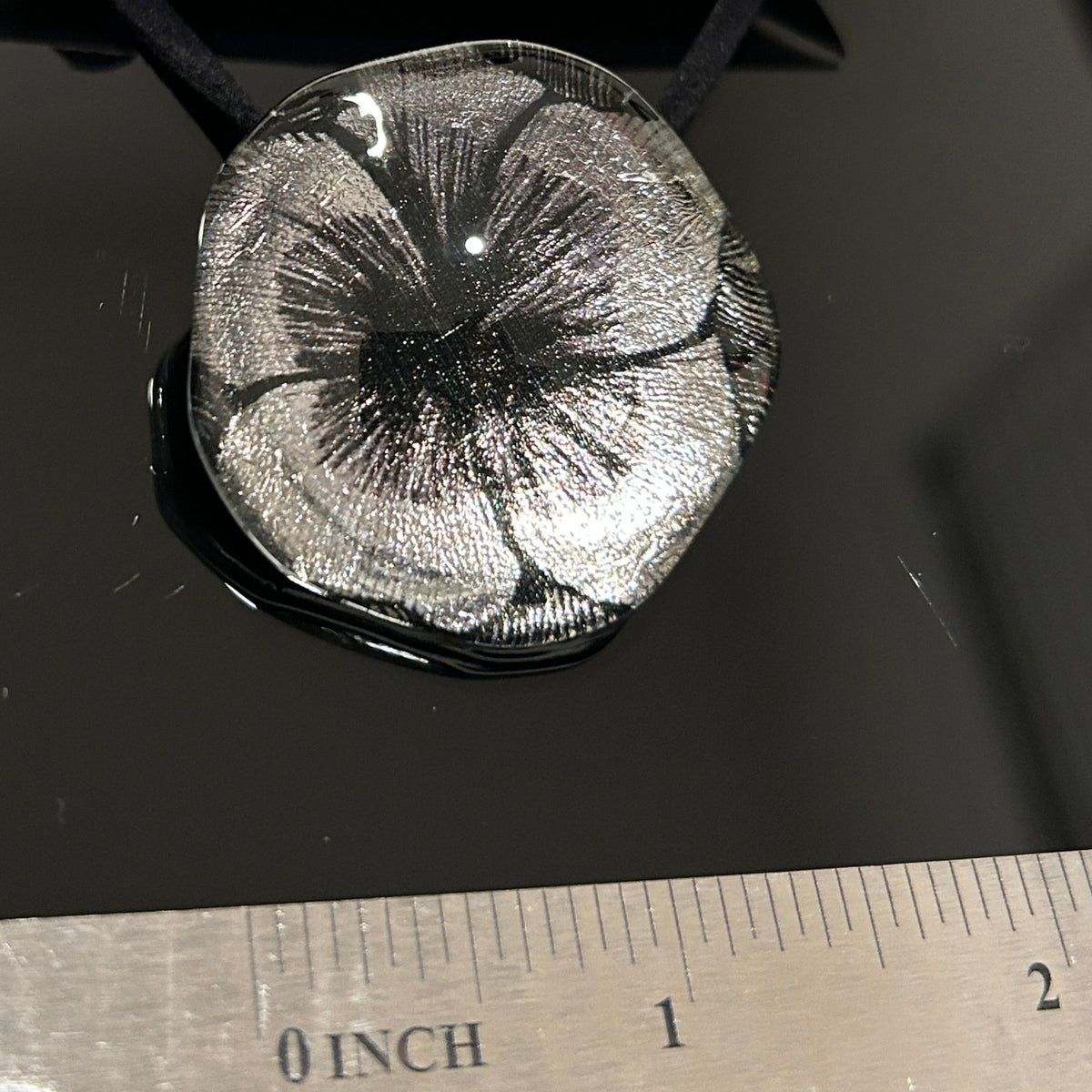 Handcrafted dichroic glass floral pendant with silver metallic flower design against dark background, Mars Glass artisan jewelry collection