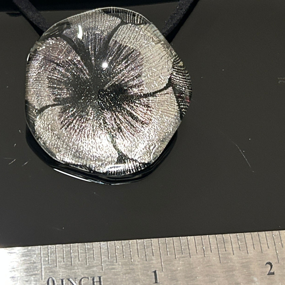 Handcrafted dichroic glass floral pendant with silver metallic flower design against dark background, Mars Glass artisan jewelry collectio